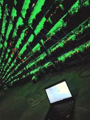Rows of mining rigs operating in a professional mining farm environment